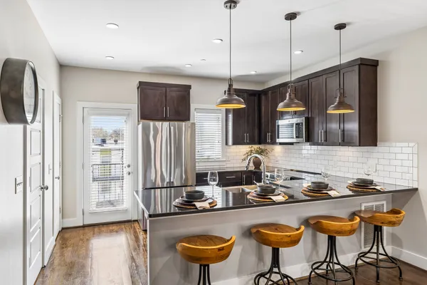 a kitchen with sink table and chairs