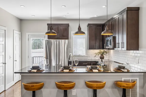 a kitchen with sink and chairs