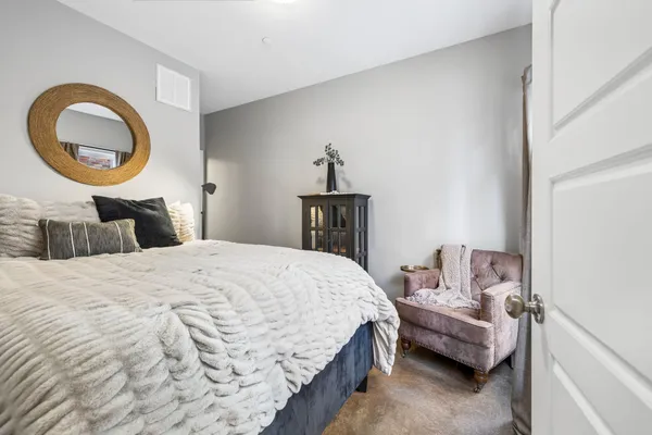 a bedroom with a bed and a lamp