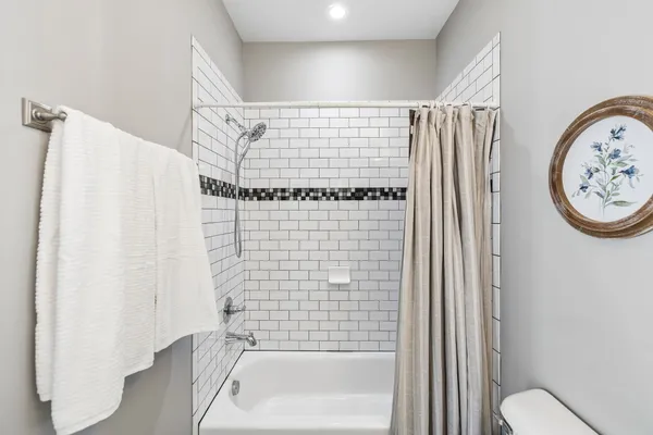 a bathroom with a shower curtain and a toilet