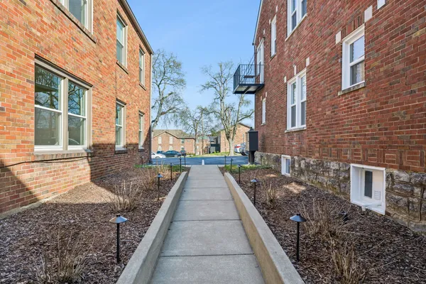 a view of a pathway with a house on the background