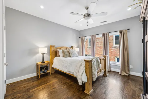 a spacious bedroom with a bed and a chandelier