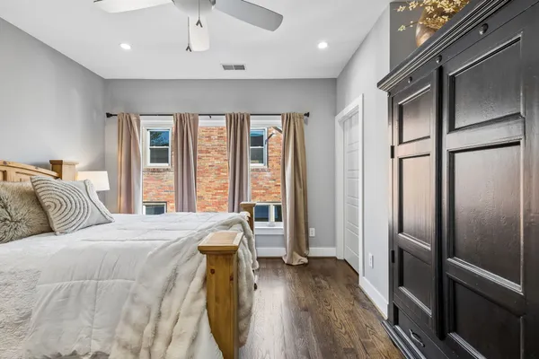 a bed room with a bed and a refrigerator