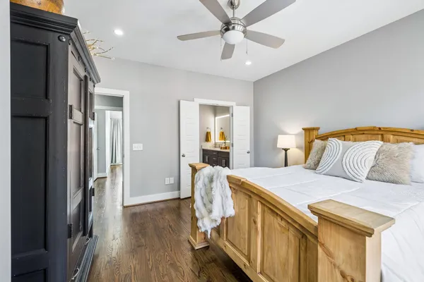 a bedroom with a bed and wooden floor