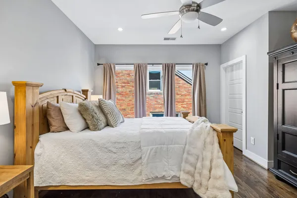 a bed sitting in a bedroom next to a window