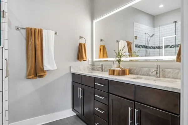 a bathroom with a double vanity sink and a mirror