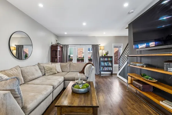 a living room with furniture and a wooden floor