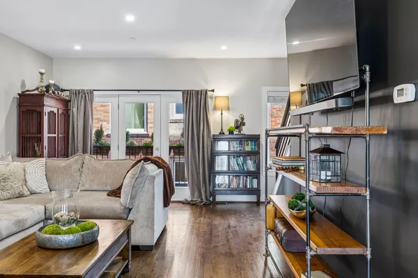 a living room with furniture a rug and a book shelf