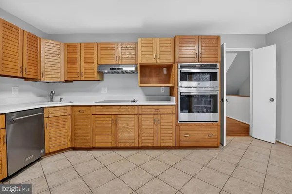a kitchen with granite countertop a sink and a stove