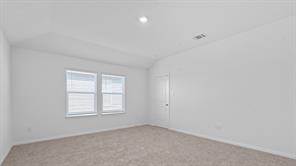 119 Morning Glory Loop Kyle, TX 78640 - Photo 11 of 24 Carpeted spare room with vaulted ceiling and recessed lighting
