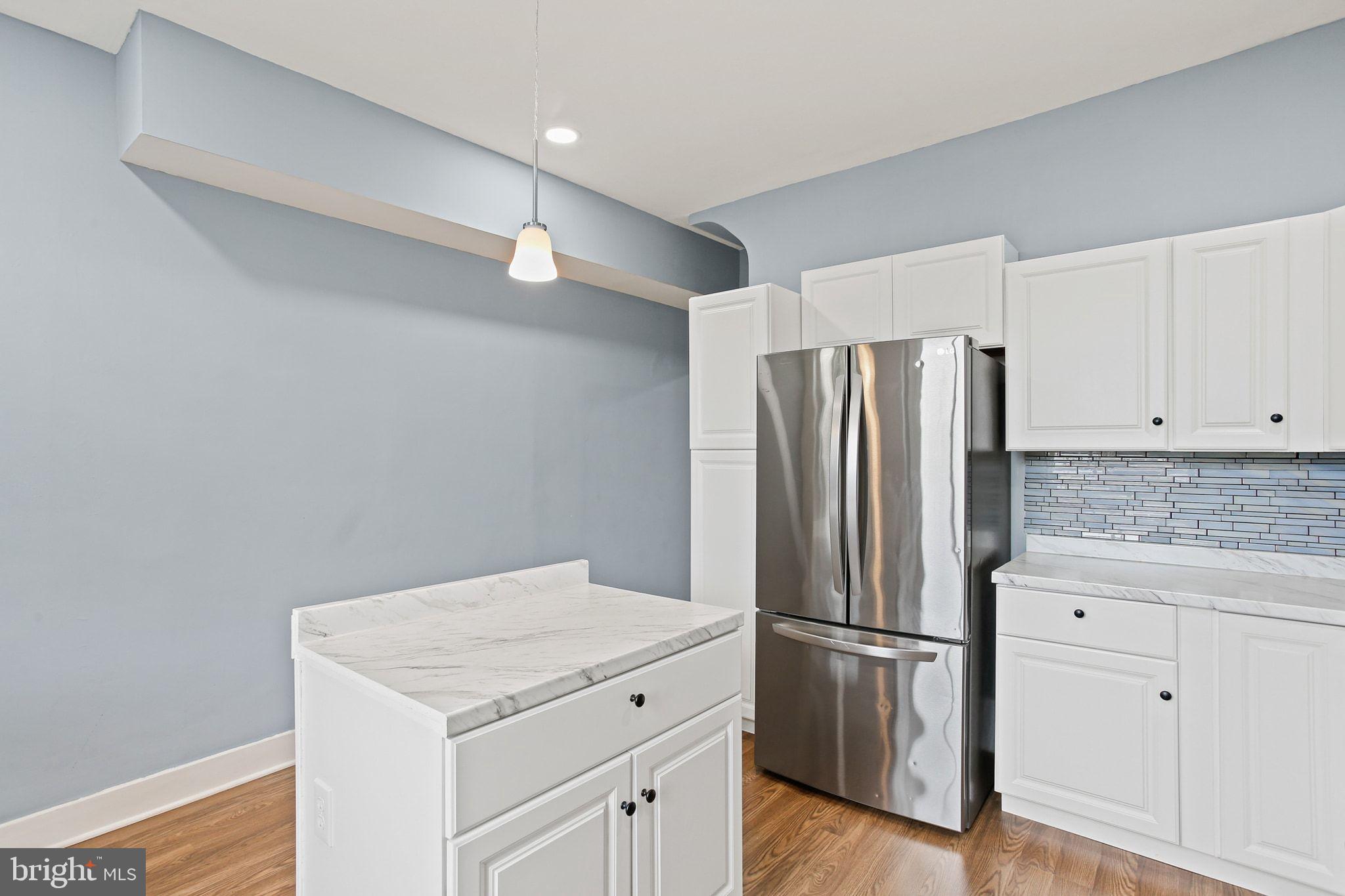 2811 Erdman Avenue Baltimore, MD 21213 - Photo 8 of 17 a kitchen with a refrigerator sink and cabinets