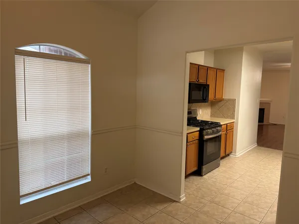 a kitchen with a refrigerator and a stove