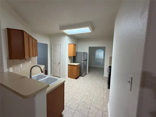 a kitchen with a sink cabinets and stainless steel appliances