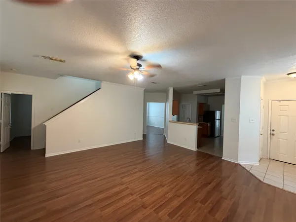 a view of a kitchen with wooden floor and a kitchen