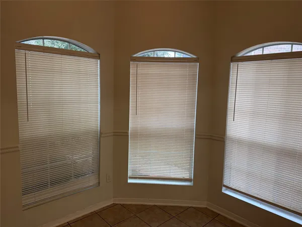 a bathroom with two window and a shower
