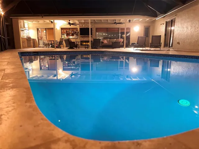a view of a swimming pool with an outdoor seating