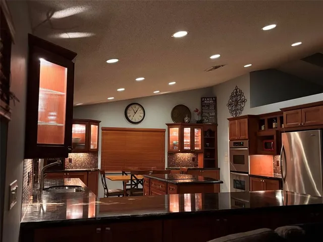 a view of a house with a small yard and palm trees