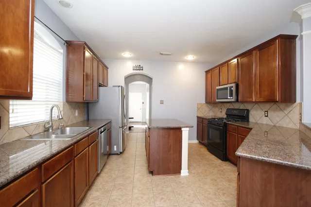 a kitchen with a sink stove and microwave