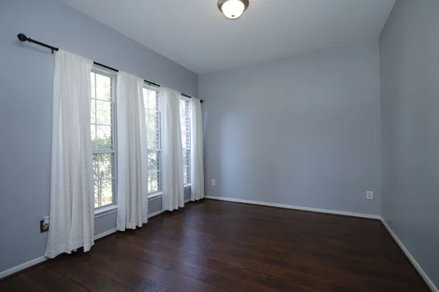 a view of wooden floor and windows in a room
