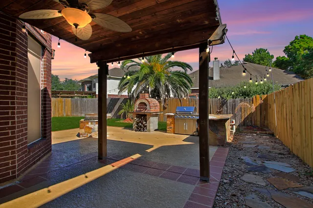 a view of a patio with a table and chairs