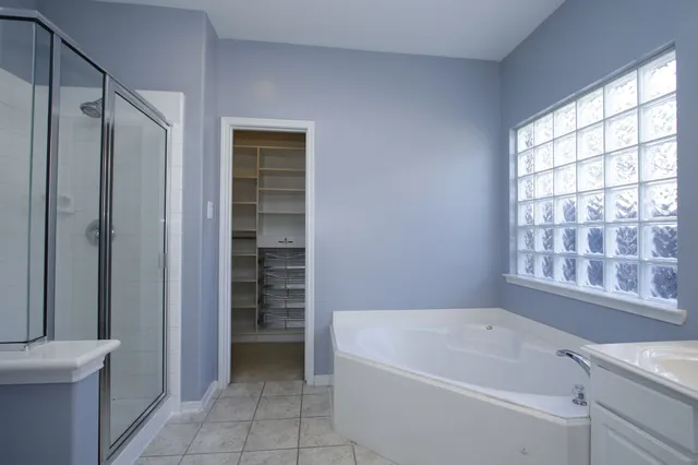 a bathroom with a bathtub and a shower