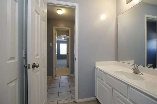a bathroom with a sink and mirror