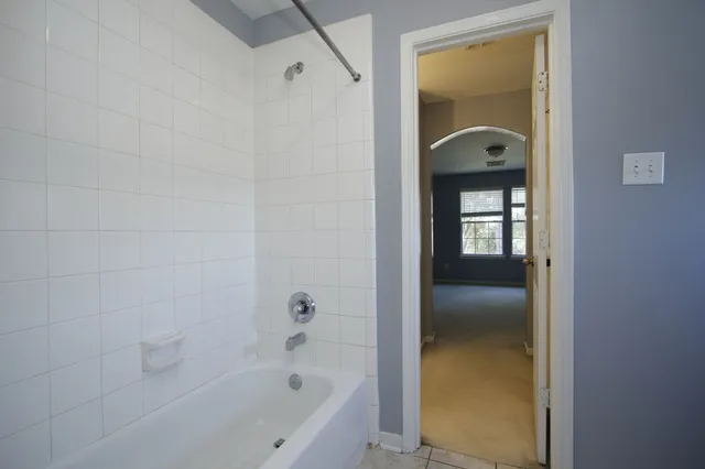 a bathroom with a bathtub and a shower