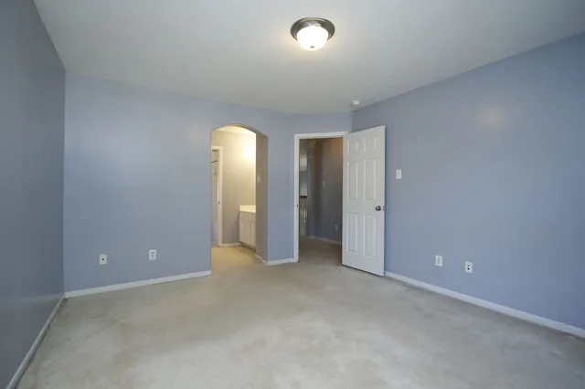 an empty room with closet and bathroom