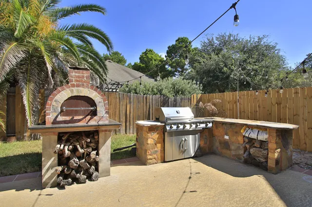 a view of a two chairs in the back yard of the house