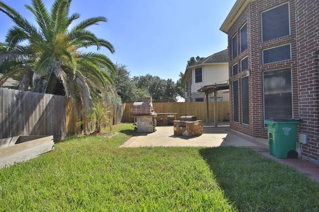 a view of a house with backyard porch and sitting area