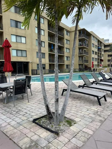 a view of a building with backyard water and sitting area