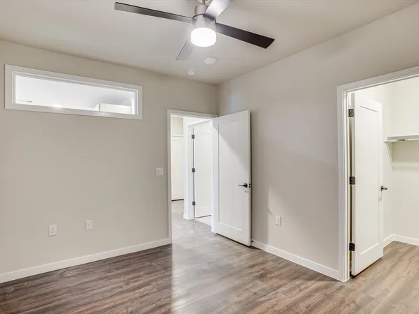 a view of an empty room with wooden floor