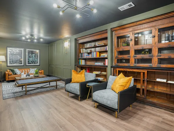 a living room with furniture and a book shelf