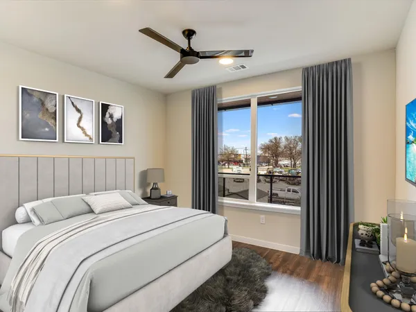 a bedroom with a large bed and a large window