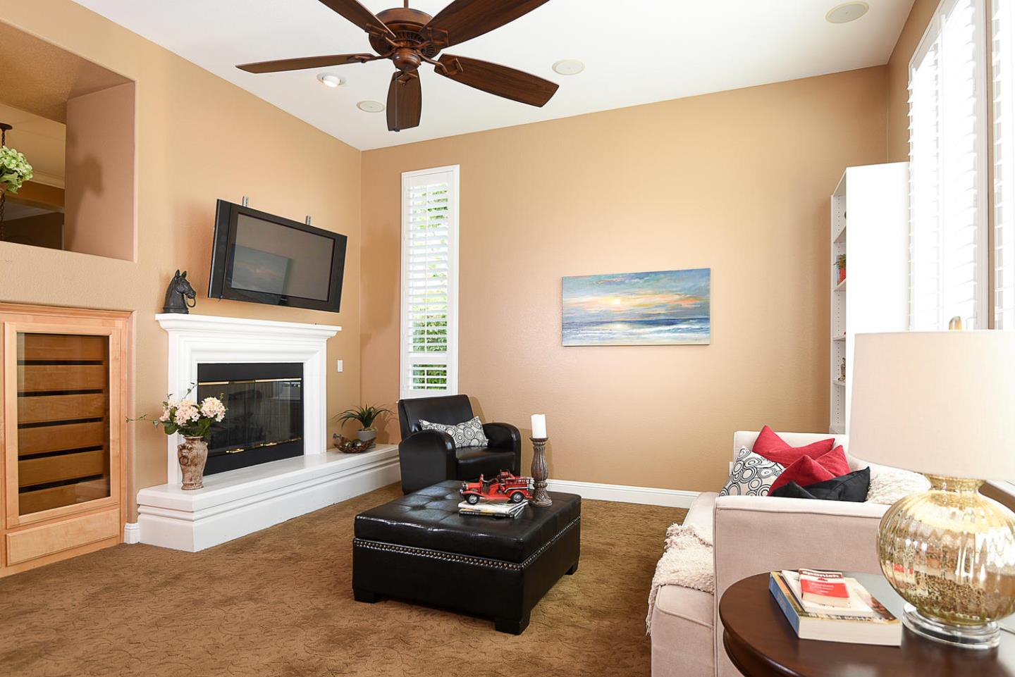1492 Red Tail Place Morgan Hill, CA 95037 - Photo 15 of 25 a living room with furniture a flat screen tv and a fireplace