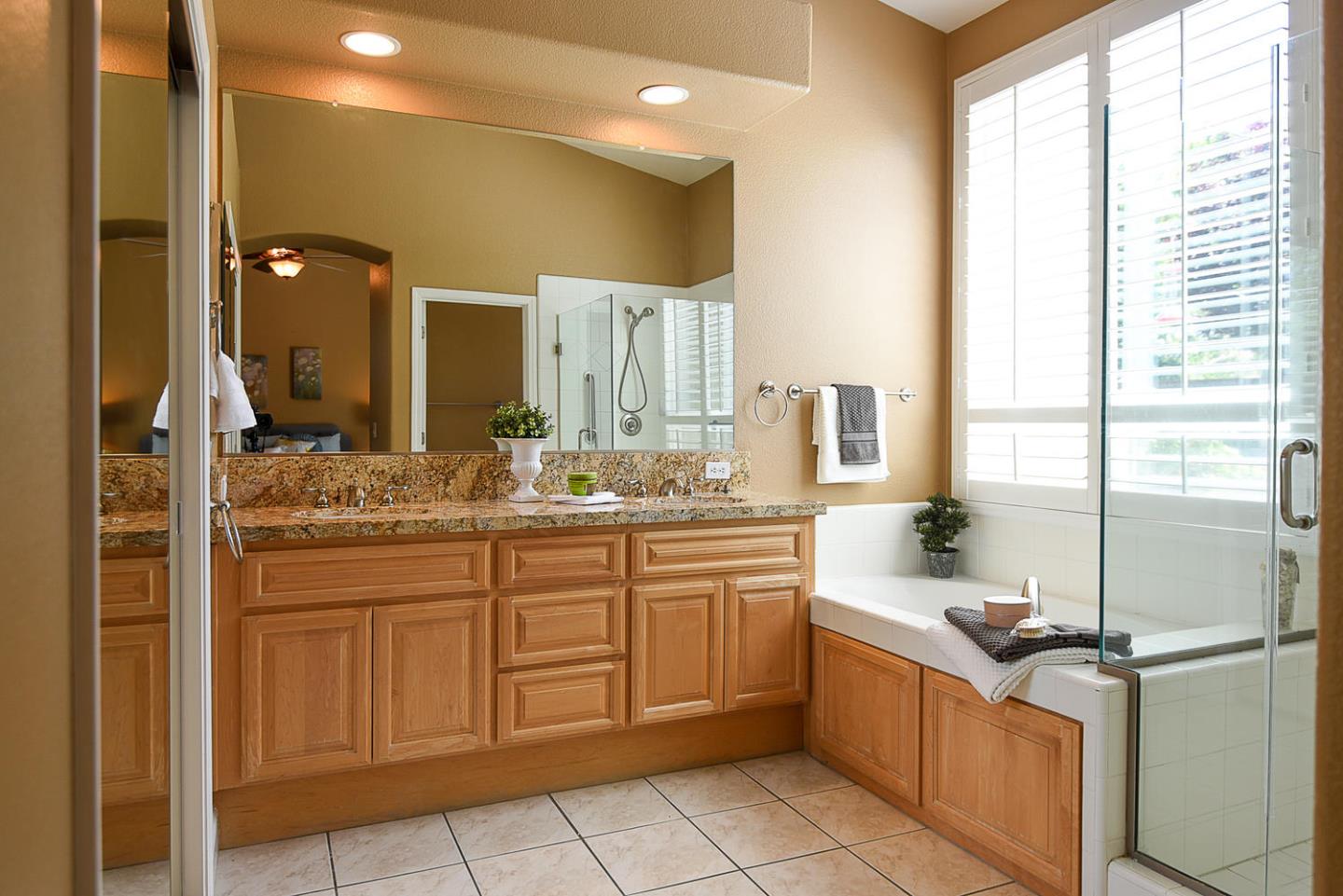 1492 Red Tail Place Morgan Hill, CA 95037 - Photo 17 of 25 a bathroom with a granite countertop sink and a mirror