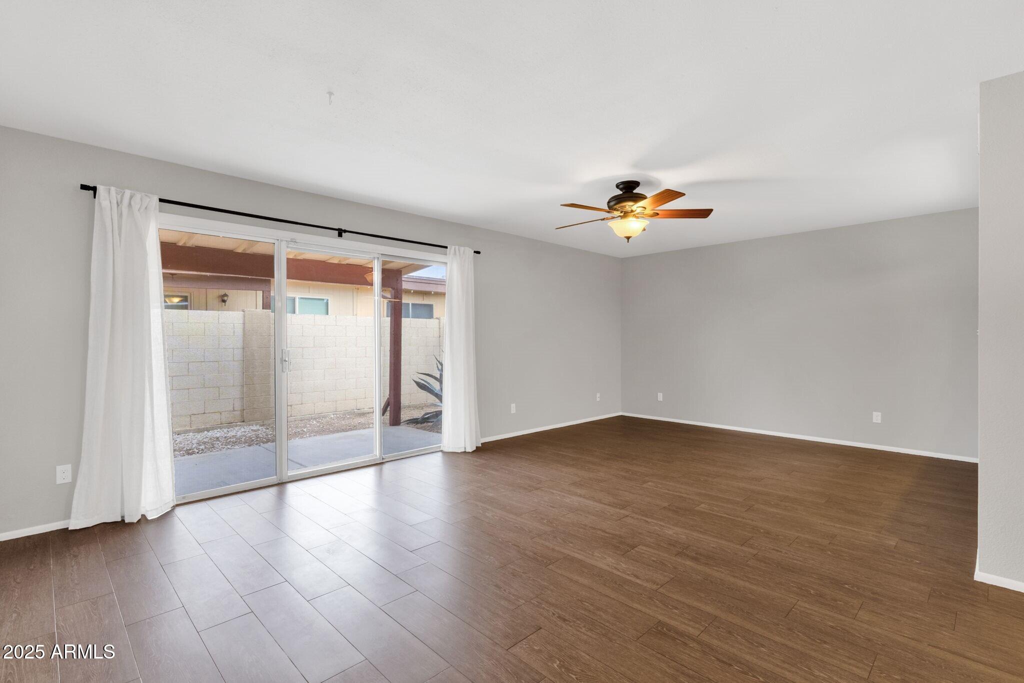 2530 East Wagoner Road Phoenix, AZ 85032 - Photo 9 of 35 an empty room with wooden floor and window