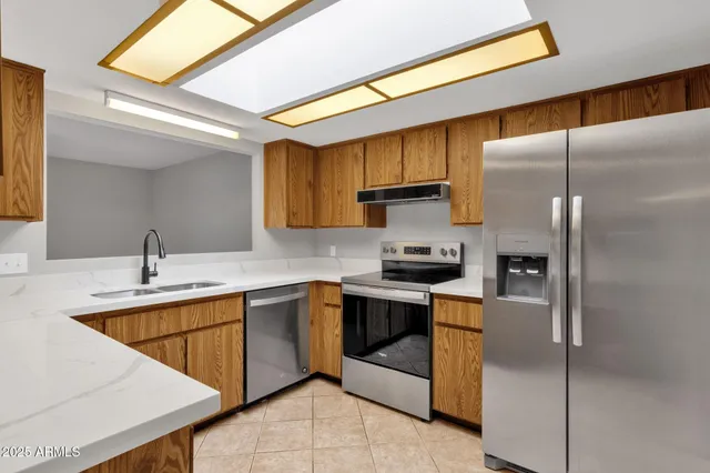a kitchen with a sink stainless steel appliances and cabinets