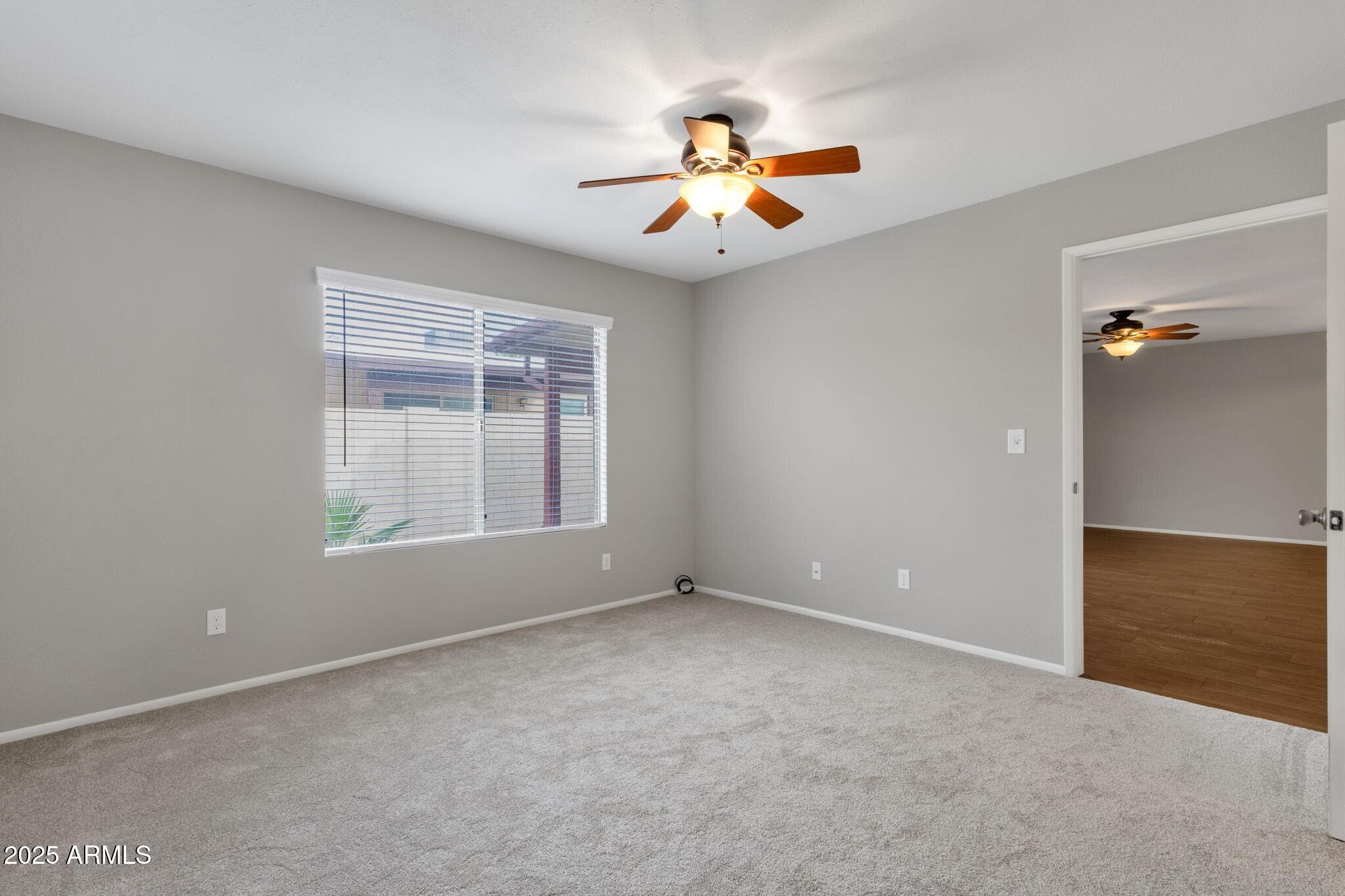 2530 East Wagoner Road Phoenix, AZ 85032 - Photo 19 of 35 an empty room with windows and fan