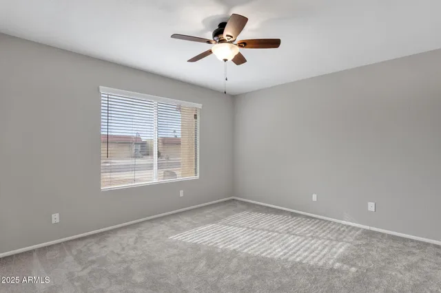 a view of a livingroom with a ceiling fan and wooden floor
