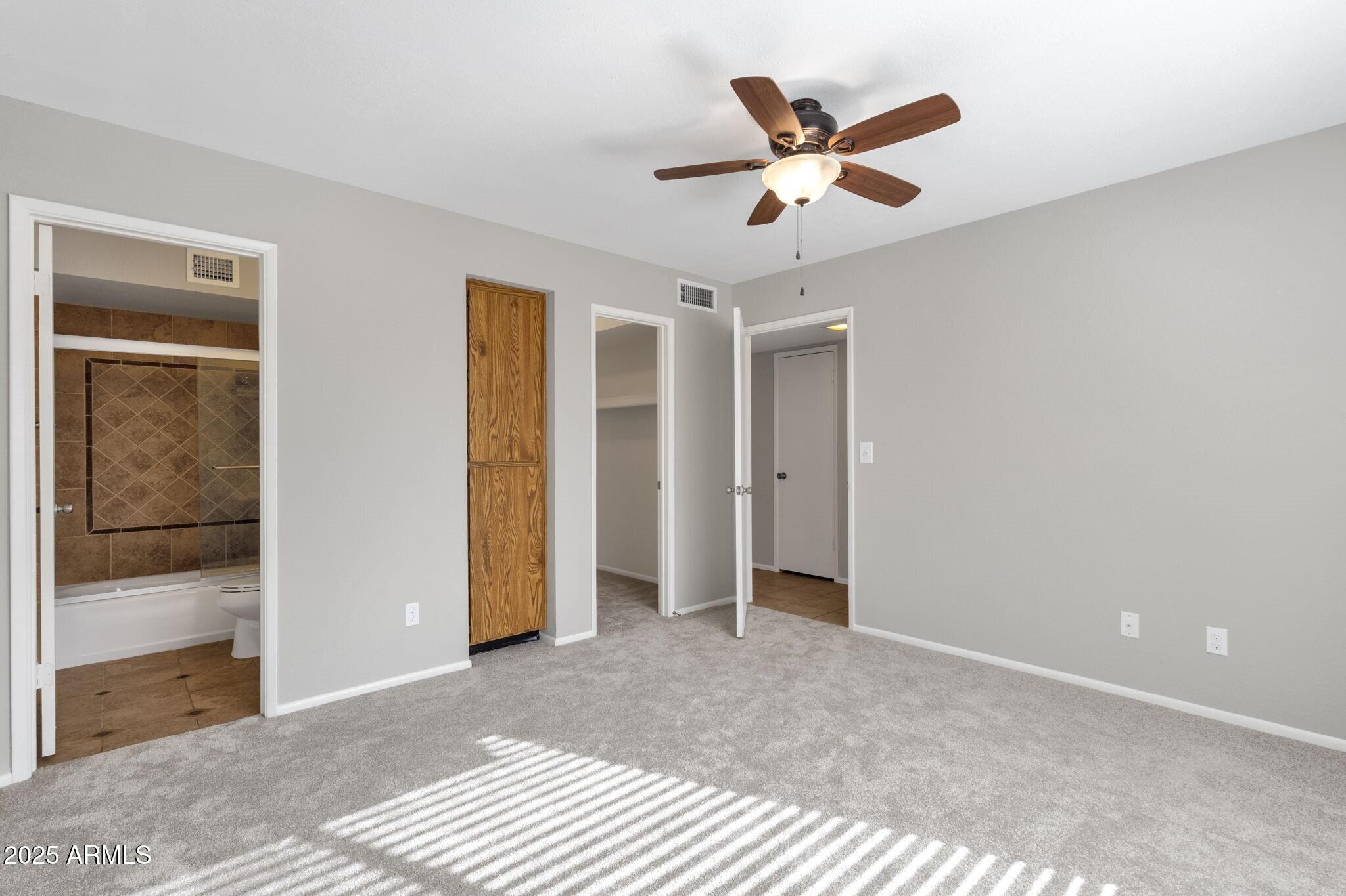 2530 East Wagoner Road Phoenix, AZ 85032 - Photo 25 of 35 a view of a livingroom with a ceiling fan and wooden floor