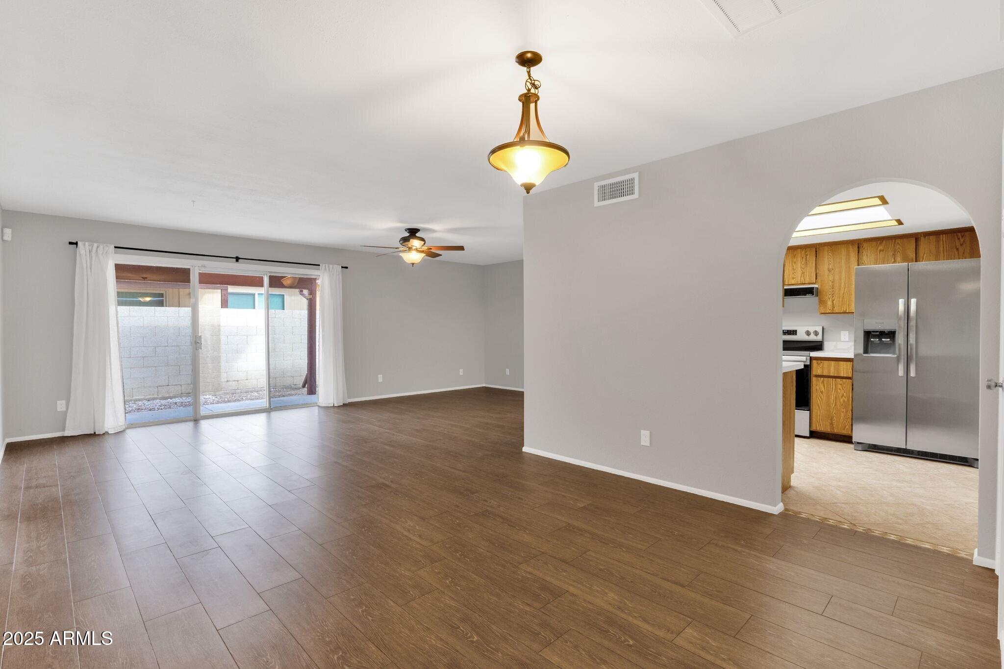 2530 East Wagoner Road Phoenix, AZ 85032 - Photo 6 of 35 a view of a kitchen with a dishwasher cabinets and wooden floor
