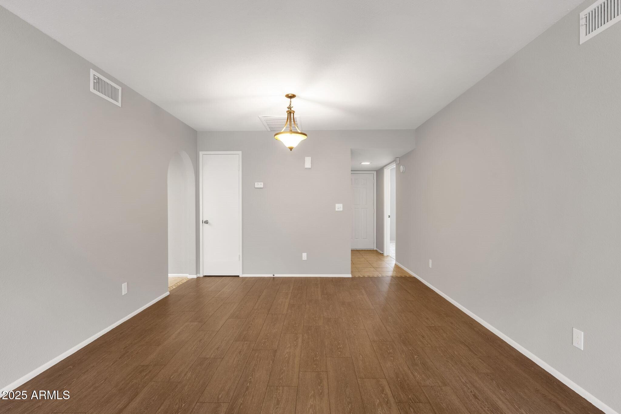 2530 East Wagoner Road Phoenix, AZ 85032 - Photo 8 of 35 wooden floor in an empty room with a window