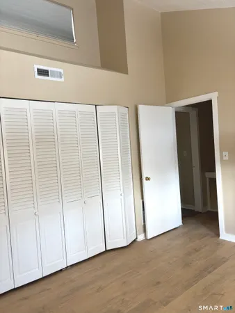 a view of an empty room with closet