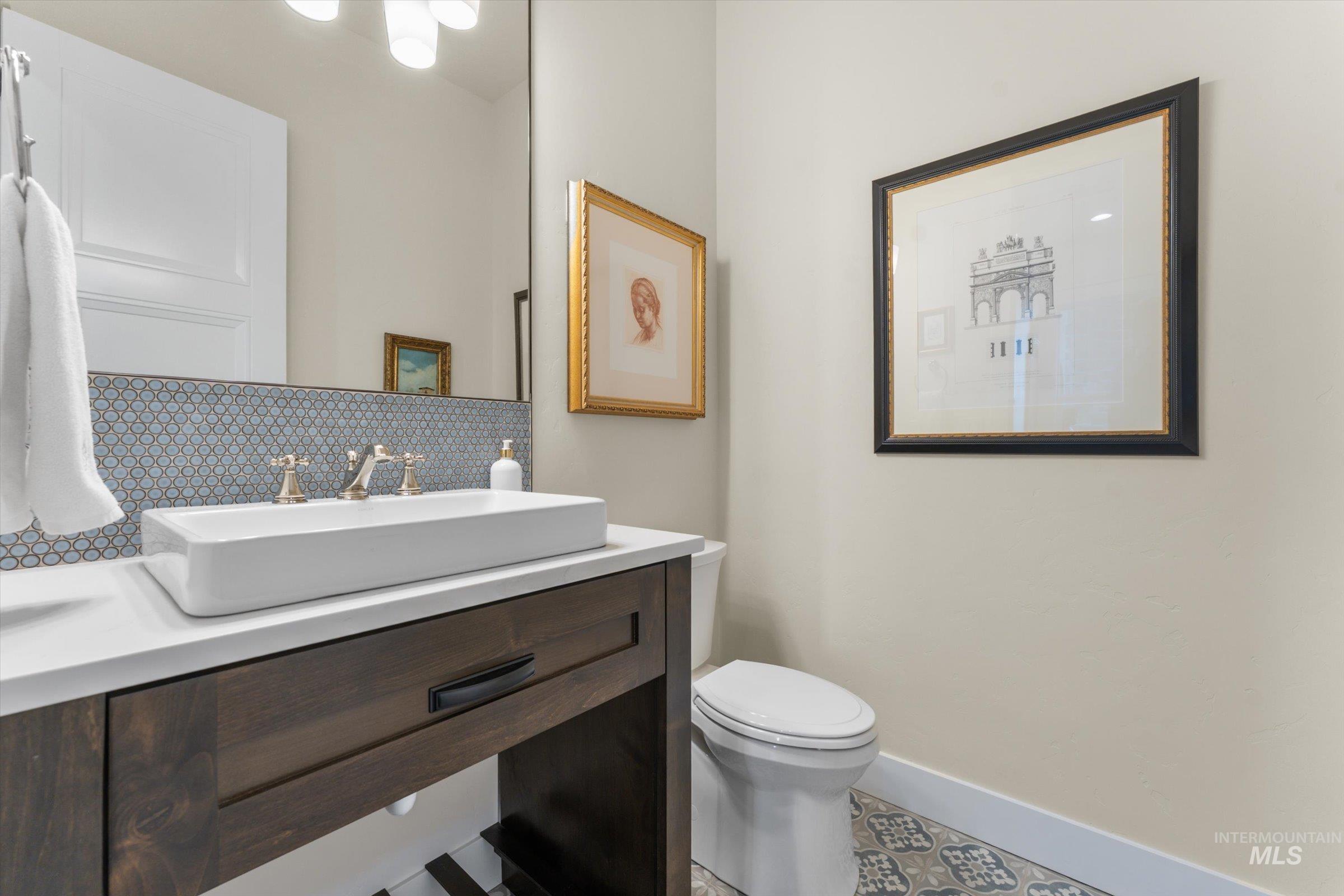 6585 South Pemberley Way Meridian, ID 83642 - Photo 21 of 43 Modern vanity with a rectangular vessel sink, brass-finish faucet, and white countertop