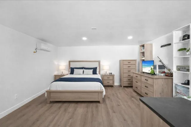 a bedroom with a bed and with furniture