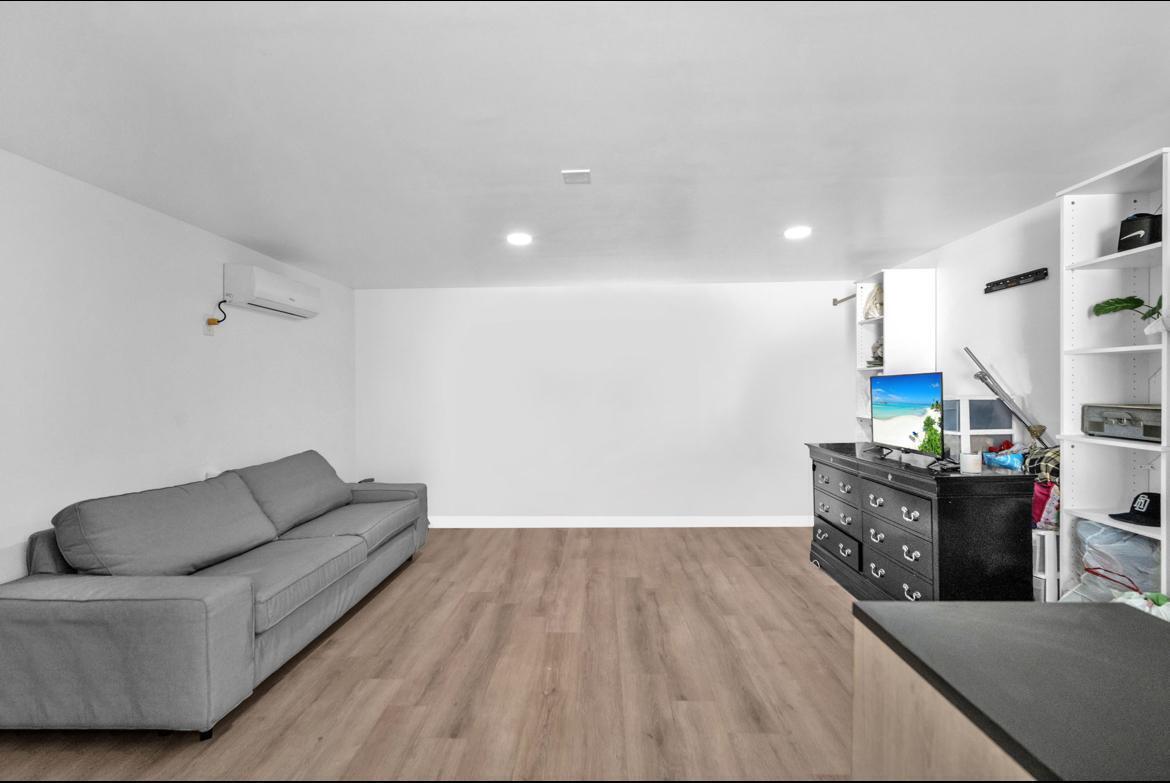 7151 Taft Street, Unit REAR Hollywood, FL 33024 - Photo 4 of 8 a living room with furniture and a wooden floor