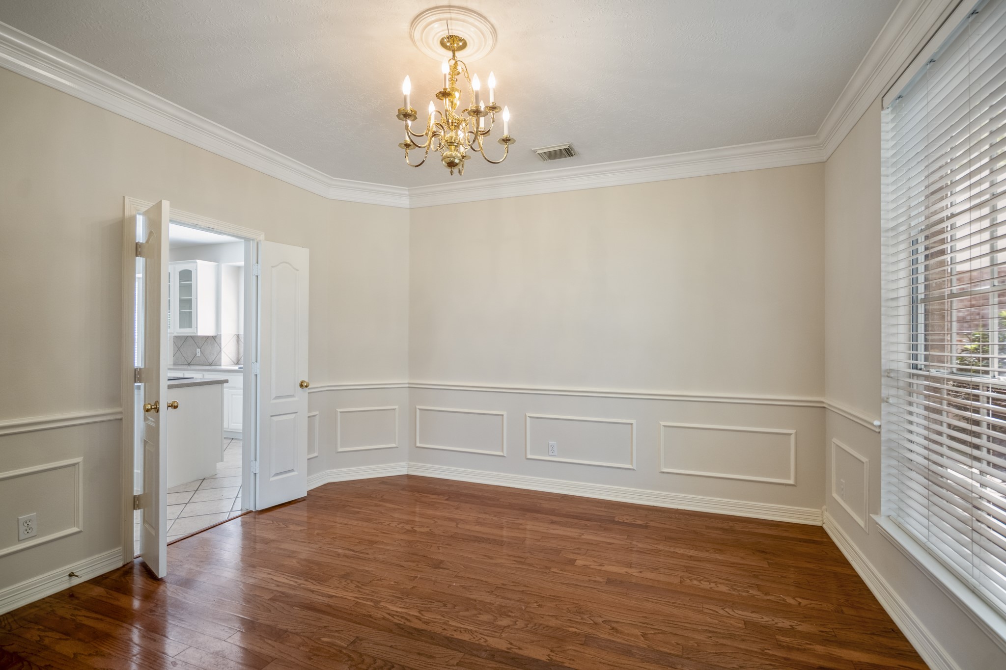 1322 Cardigan Bay Circle Spring, TX 77379 - Photo 11 of 50 The elegant formal dining room, features hardwood floors & crown molding with beautiful millwork, a large window and double doors to the kitchen.