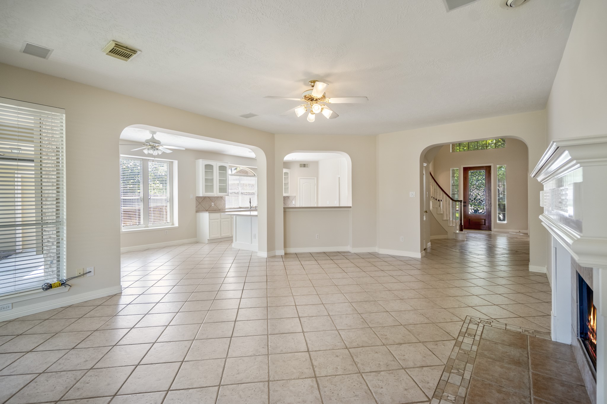 1322 Cardigan Bay Circle Spring, TX 77379 - Photo 12 of 50 The family room features several wide arched doorways that lead to other parts of the house, including a kitchen/breakfast nook area to the left and an entryway with a staircase to the right.