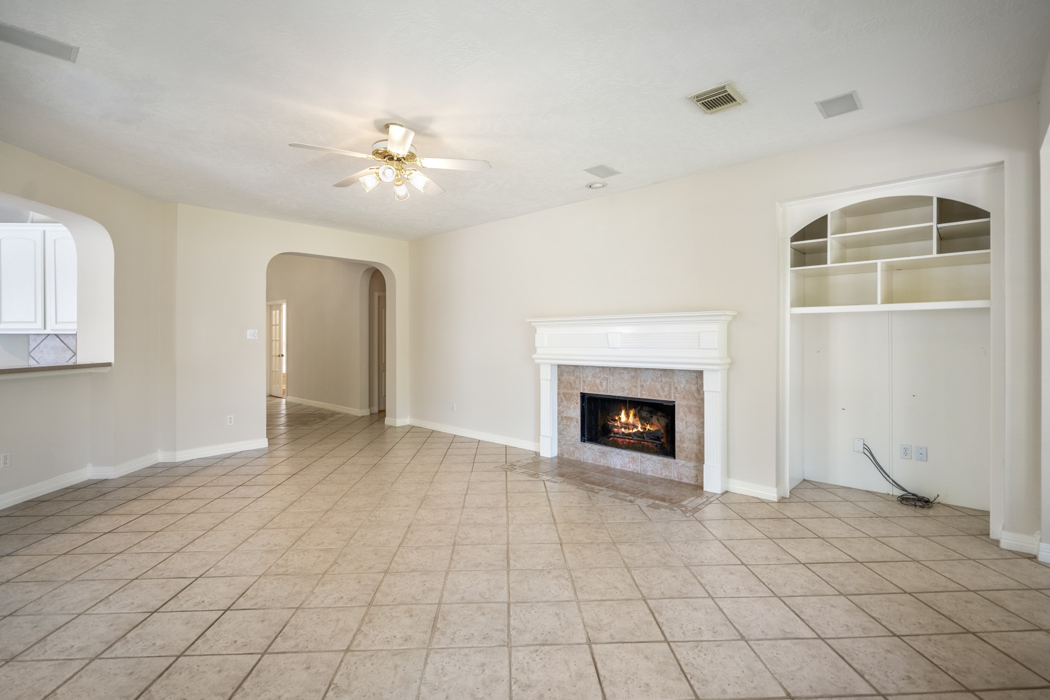 1322 Cardigan Bay Circle Spring, TX 77379 - Photo 14 of 50 The living room features several wide arched doorways that lead to other parts of the home, including a kitchen/dining area.